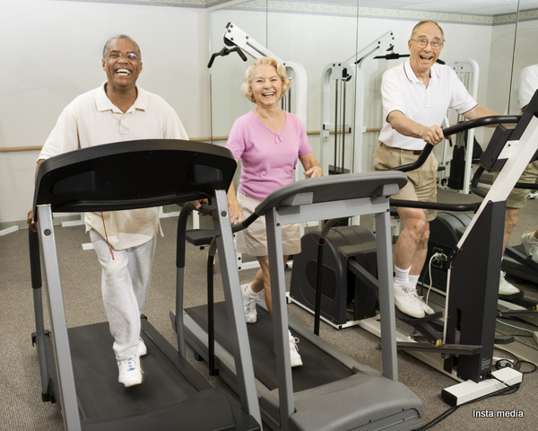 Elderly people working out in gym