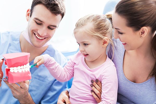 child plays role of dentist