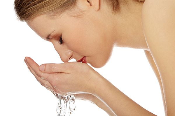 Young female washing her face