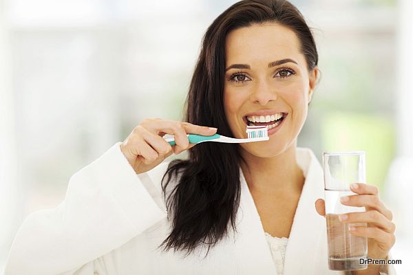 Cute woman brushes her teeth