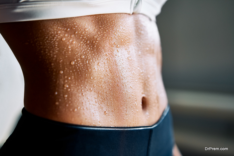  woman torso with sweat on skin after workout