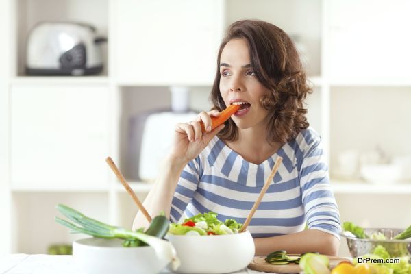 Woman is eating carrot