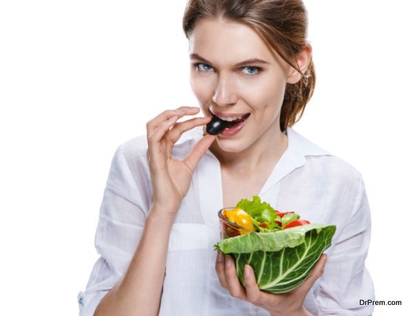 seductive european woman & vegetable salad - isolated on white background