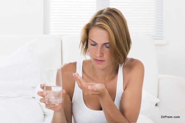 Woman Holding Medicine And Glass Of Water