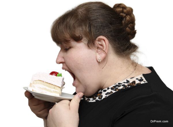 overweight woman greedy biting sweet cake on white background