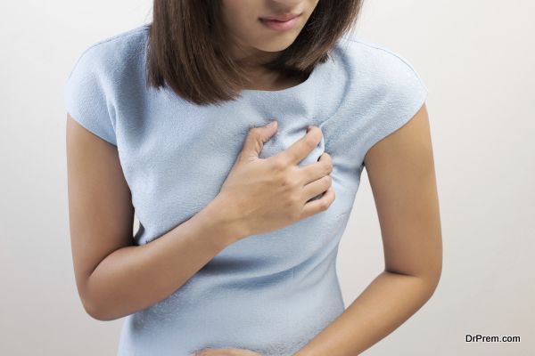 Woman is clutching her chest, acute pain possible Heart attack