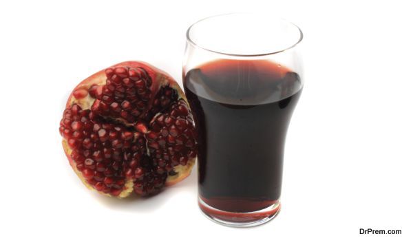 fresh pomegranate juice on a white background