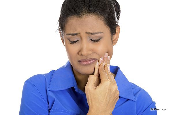 Young woman with sensitive tooth ache crown problem