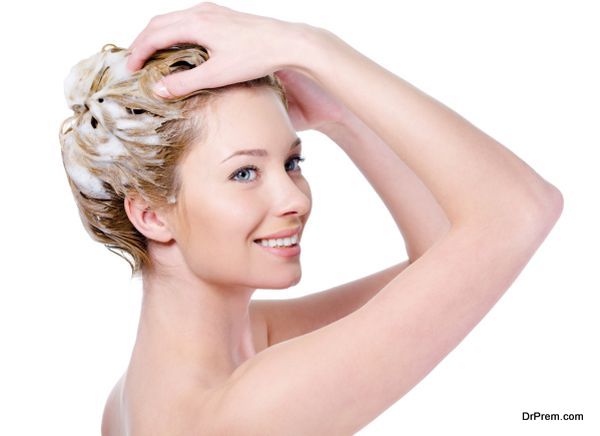 Woman washing hair with shampoo