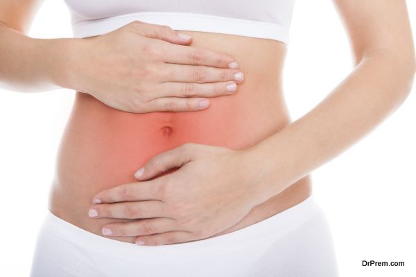 Young Woman With Pain In Her Stomach Isolated Over White Background