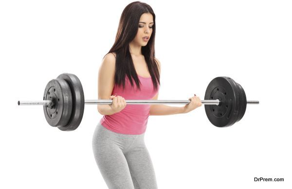 Attractive woman lifting a barbell