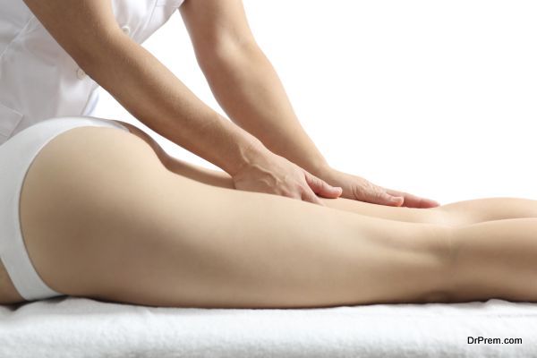 Side view of a woman legs receiving massage therapy