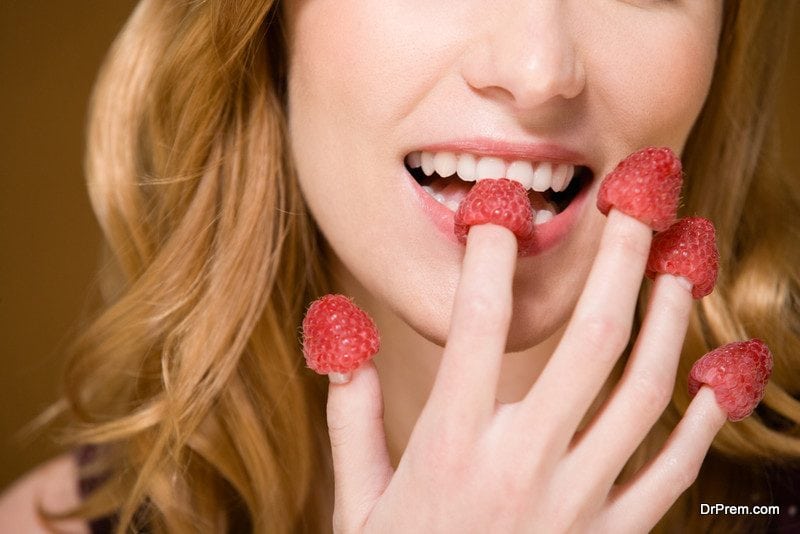 Woman eating raspberries