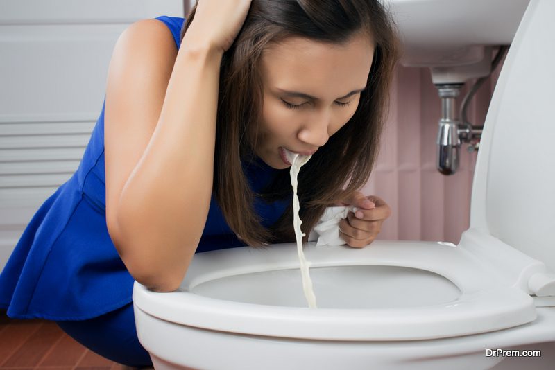 Woman vomiting in toilet