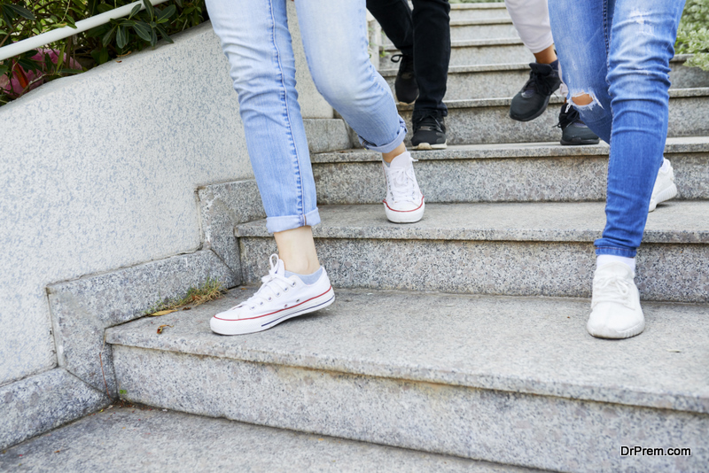 Feet of young people walking down the stairs in the street